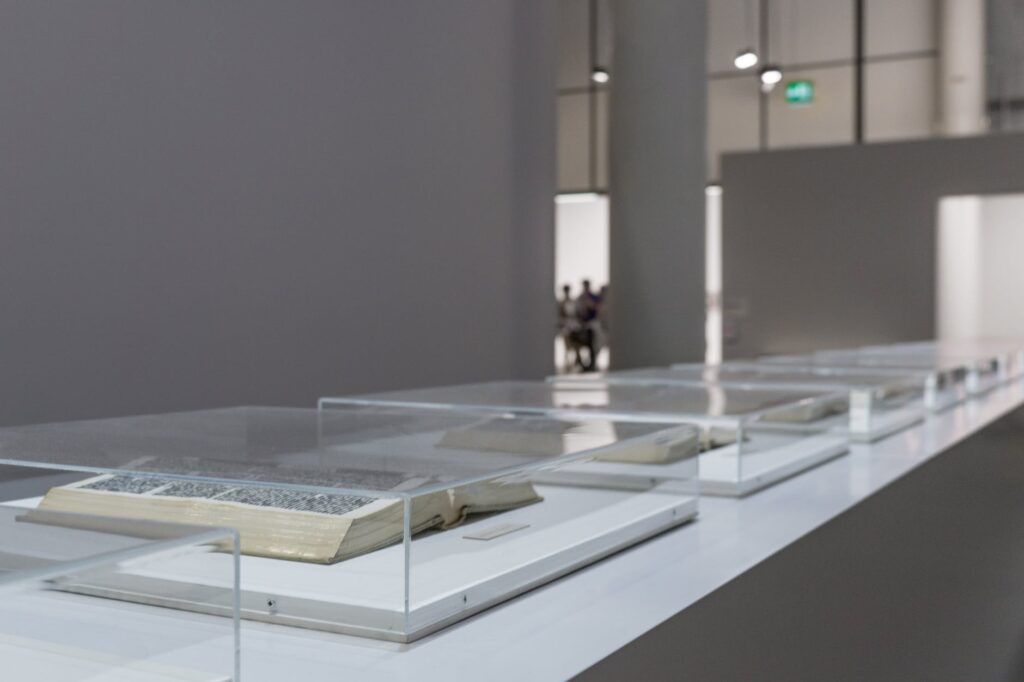open books with glass case inside room
